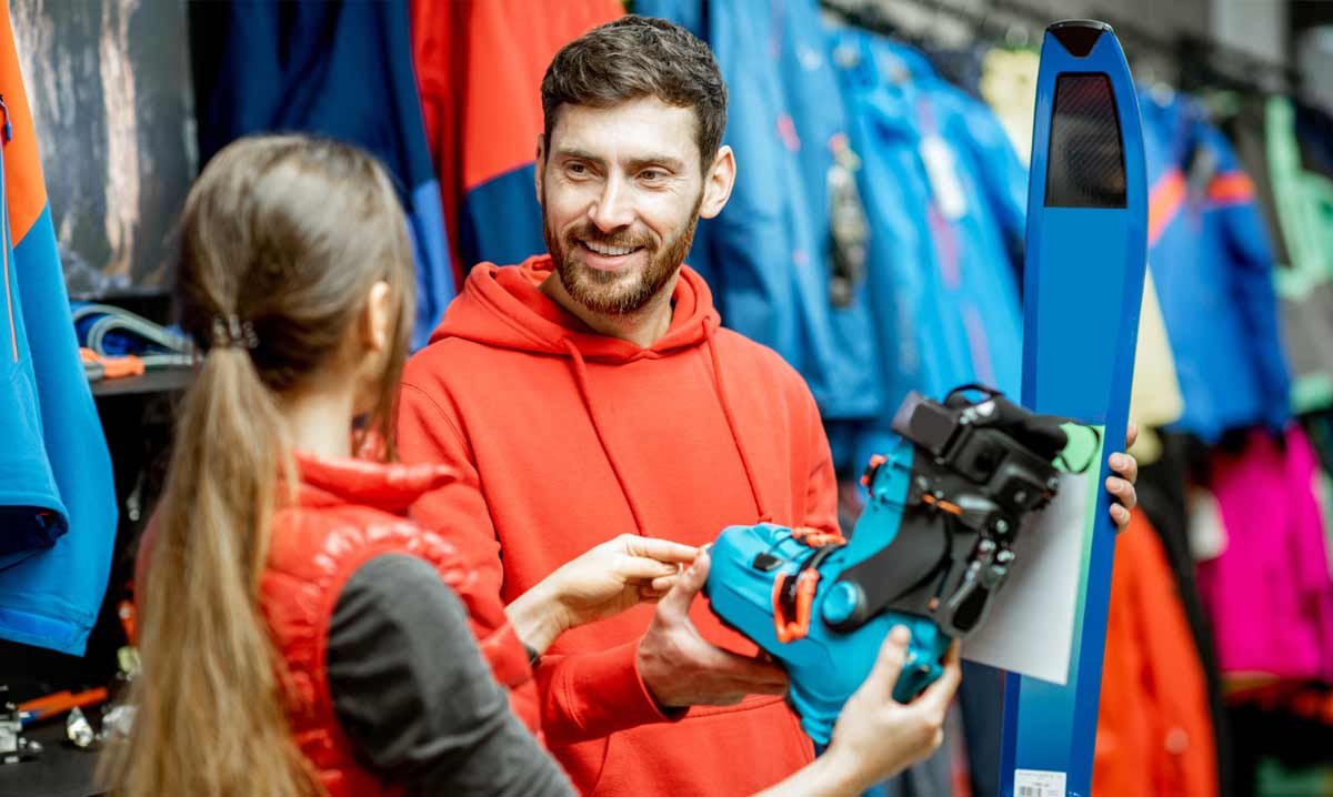 Guy holding a ski boot in ski shop