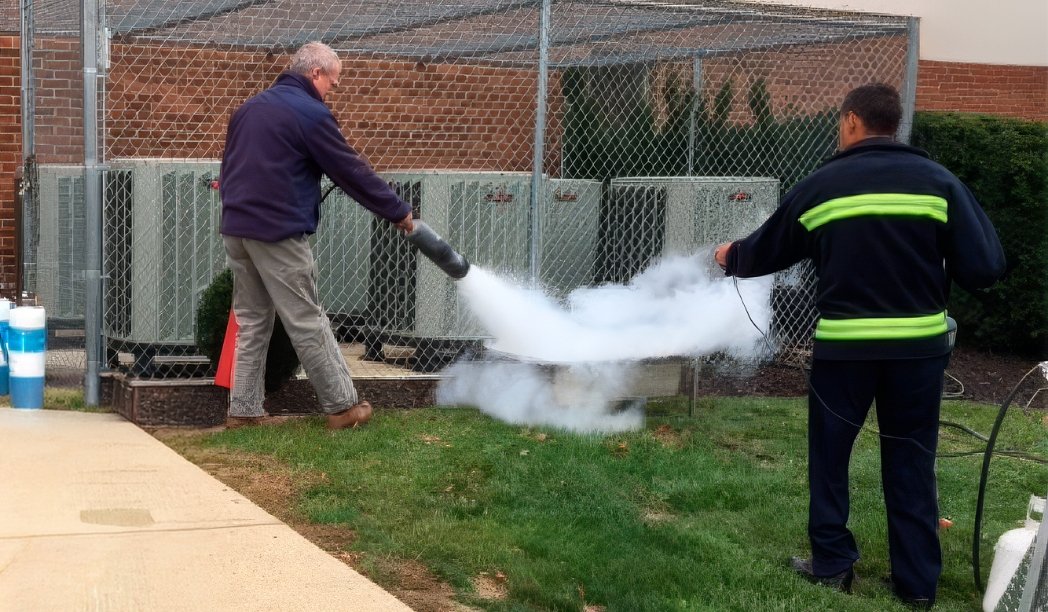 man using extinguisher to put out a fire
