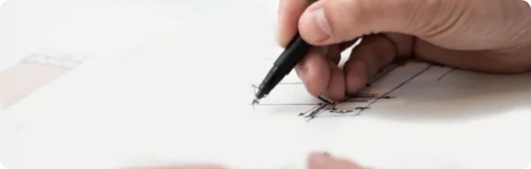 hand holding pen and working on prototypes